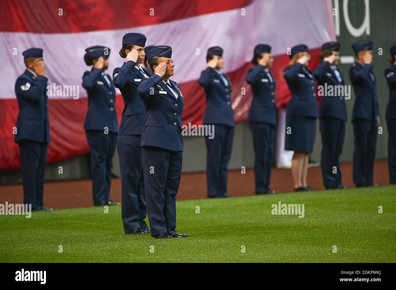 Col. Katrina Stephens, installation commander, and 30 other Airmen from Hanscom Air Force Base, Mass., salute while the national anthem is played prior to a Boston Red Sox game at Fenway Park in Boston on Flag Day, June. 14. Stock Photo