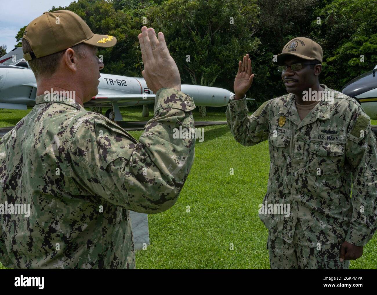 KADENA, Japan (Jun. 15, 2021) Capt. Scott Hardy, Commander, Fleet Activities Okinawa commanding officer, left, administers the oath of office and swears in Senior Chief Frederick Joshua, from Baltimore, MD and assigned to CFAO security, as an ensign in the U.S. Navy at Kadena Air Base, Okinawa, Japan Jun. 15, 2021. Joshua was commissioned into the U.S. Naval Medical Service Corps (MSC) through the MSC In-Service Procurement Program. It allows Sailors in pay grades E-5 through E-9 who meet certain eligibility criteria to directly commission into MSC and attend fully-funded training to complete Stock Photo