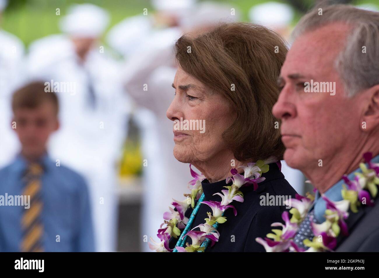 Family members of the Trapp Brothers watch as military honors are rendered during a funeral for the Trapp brothers at the National Memorial Cemetery of the Pacific, Honolulu, Hawaii, June 15, 2021. The Trapp brothers were assigned to the USS Oklahoma, which sustained fire from Japanese aircraft and multiple torpedo hits causing the ship to capsize and resulted in the deaths of more than 400 crew members on Dec. 7, 1941, at Ford Island, Pearl Harbor. The Trapp brothers were recently identified through DNA analysis by the Defense POW/MIA Accounting Agency (DPAA) forensic laboratory and laid to r Stock Photo