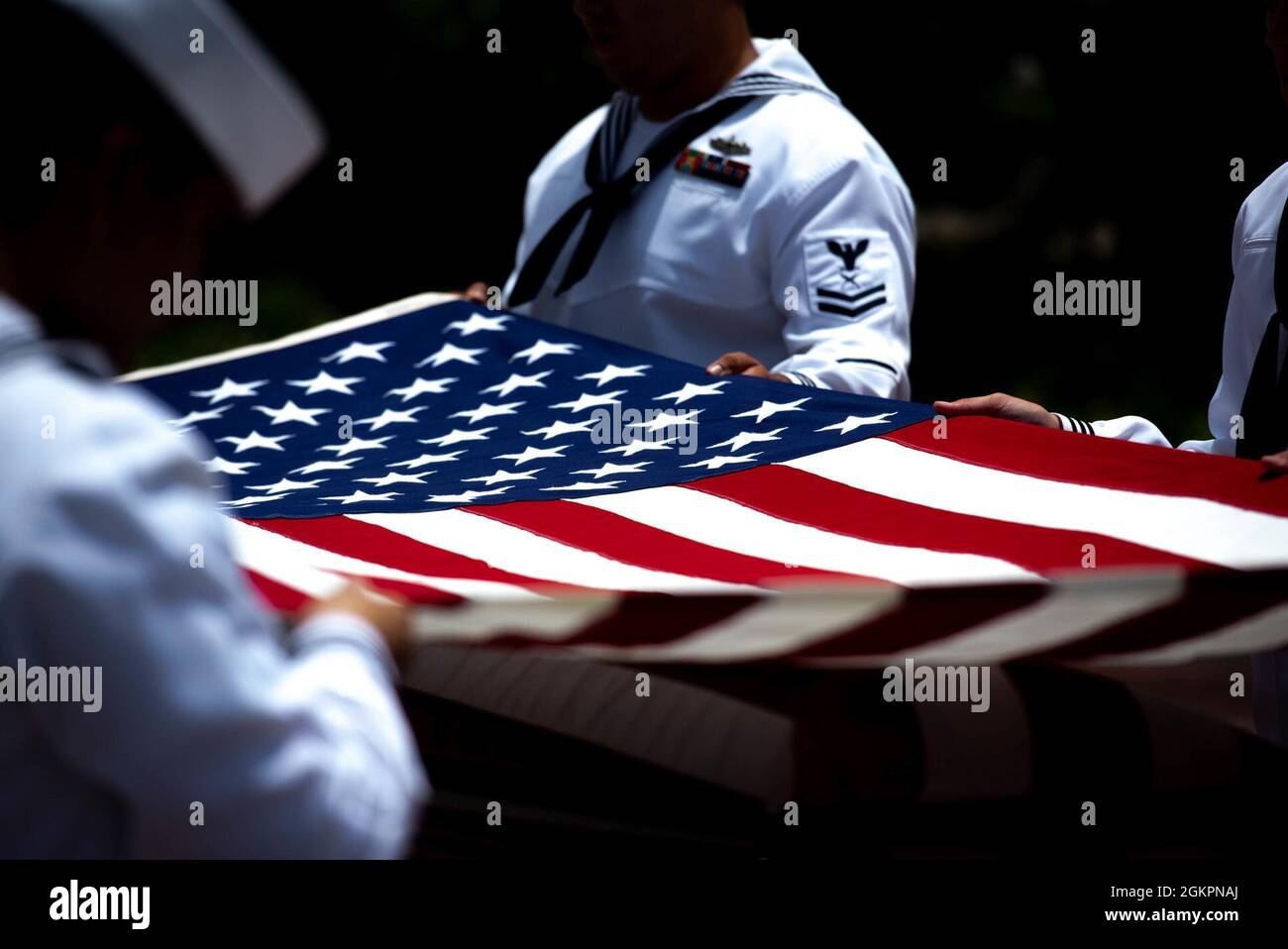 Members of the U.S. Navy Region Hawaii Honor Guard fold an American flag during a funeral for the Trapp brothers at the National Memorial Cemetery of the Pacific, Honolulu, Hawaii, June 15, 2021. The Trapp brothers were assigned to the USS Oklahoma, which sustained fire from Japanese aircraft and multiple torpedo hits causing the ship to capsize and resulted in the deaths of more than 400 crew members on Dec. 7, 1941, at Ford Island, Pearl Harbor. The Trapp brothers were recently identified through DNA analysis by the Defense POW/MIA Accounting Agency (DPAA) forensic laboratory and laid to res Stock Photo