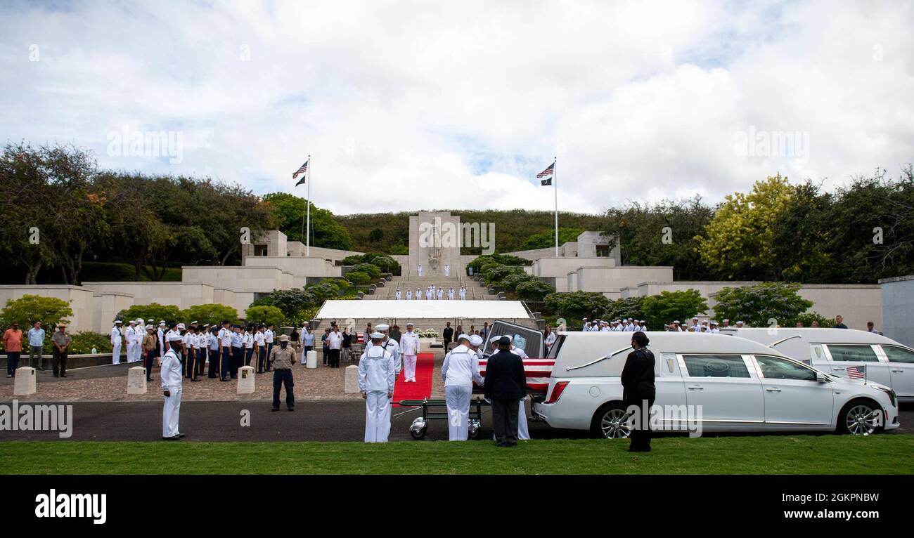 Members of the U.S. Navy Region Hawaii Honor Guard lift a casket during a funeral for the Trapp brothers at the National Memorial Cemetery of the Pacific, Honolulu, Hawaii, June 15, 2021. The Trapp brothers were assigned to the USS Oklahoma, which sustained fire from Japanese aircraft and multiple torpedo hits causing the ship to capsize and resulted in the deaths of more than 400 crew members on Dec. 7, 1941, at Ford Island, Pearl Harbor. The Trapp brothers were recently identified through DNA analysis by the Defense POW/MIA Accounting Agency (DPAA) forensic laboratory and laid to rest with f Stock Photo