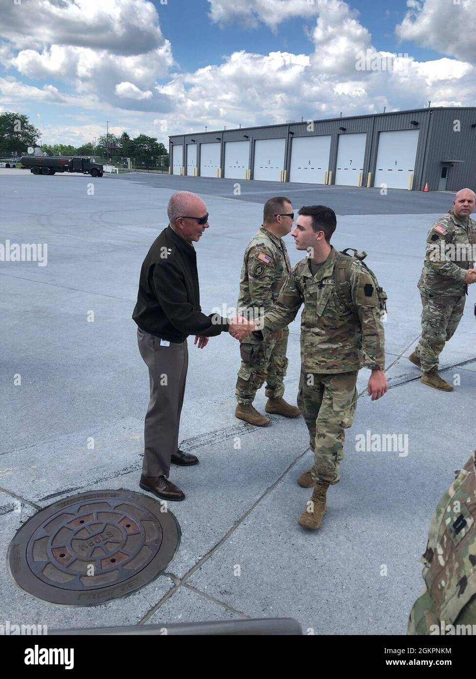 Maj. Gen. Mark Schindler, left, acting adjutant general of Pennsylvania, shakes hands with a Soldier from 1st Squadron, 104th Cavalry Regiment, 2nd Infantry Brigade Combat Team at Harrisburg International Airport in Middletown, Pa., on June 15, 2021. More than 200 Soldiers from 1-104th Cav. departed June 15 for a deployment to the Middle East. They will first travel to Fort Bliss, Texas, for pre-deployment training. Stock Photo