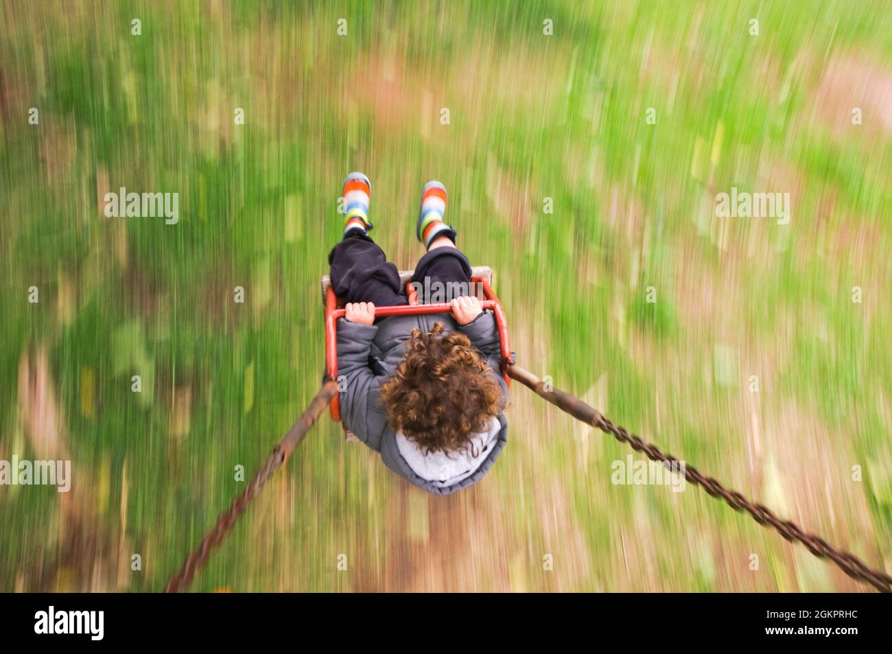 Toddler on a swing. Camera Panning Technic Stock Photo