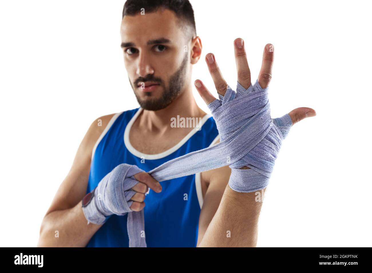 Portrait of professional boxer tying boxing handwraps isolated over