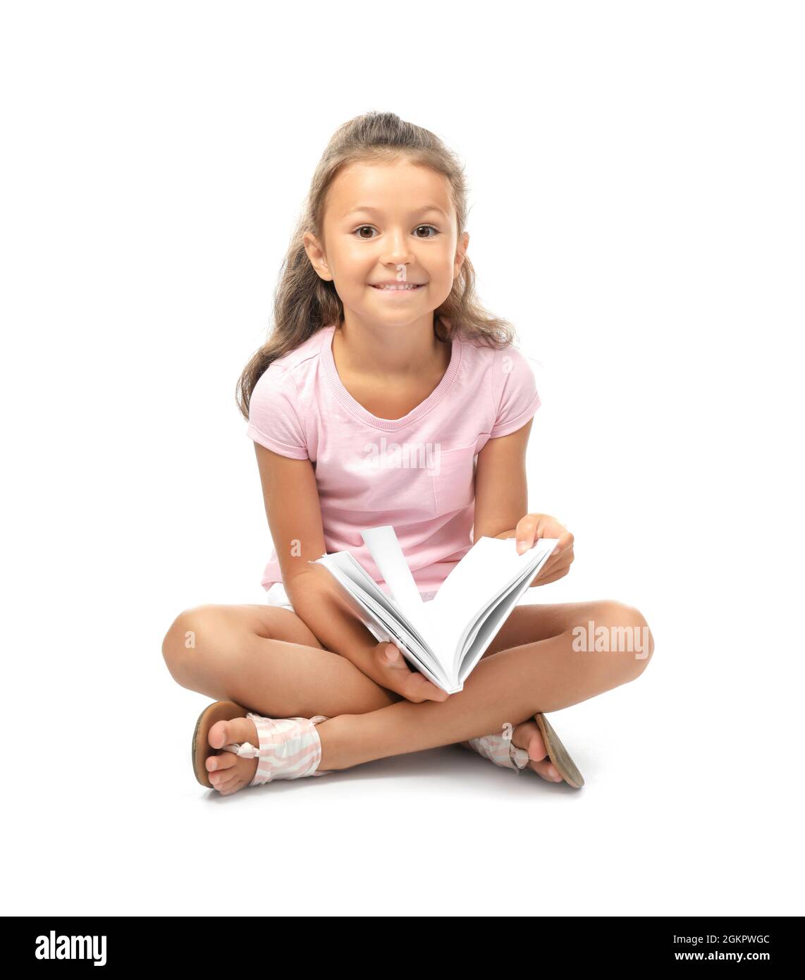 Cute little girl reading book on white background Stock Photo - Alamy