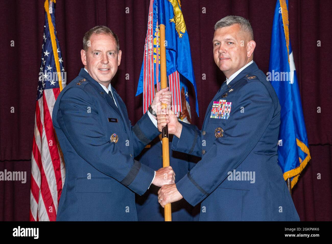 Maxwell AFB, Ala. – Lieut. Gen. James B. Hecker, Commander and President, Air University, passes the guidon to Col. Anthony Babcock at the Thomas N. Barnes Center for Enlisted Education assumption of command ceremony, June 15, 2021. Stock Photo