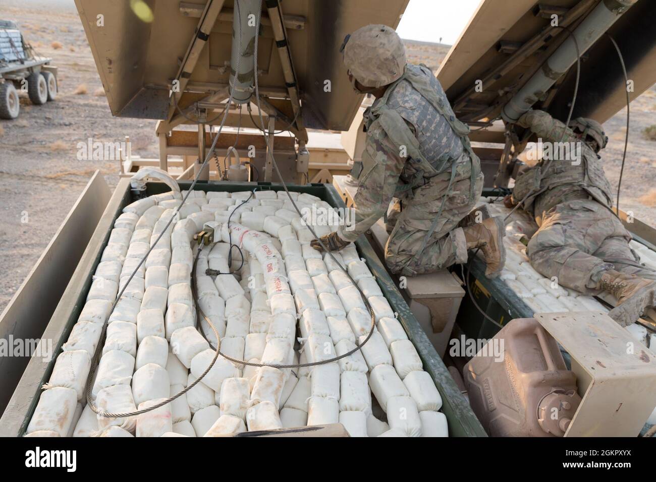 soldiers-of-the-150th-engineer-battalion-155th-armored-brigade-combat-team-mississippi-army-national-guard-prepare-an-m58-mine-clearing-line-charge-mounted-on-an-m1-assault-breacher-vehicle-for-live-fire-at-the-national-training-center-fort-irwin-california-june-16-2021-the-miclic-fires-3200-pounds-of-explosives-that-clear-landmines-so-vehicles-and-troops-can-safely-pass-2GKPXYX.jpg