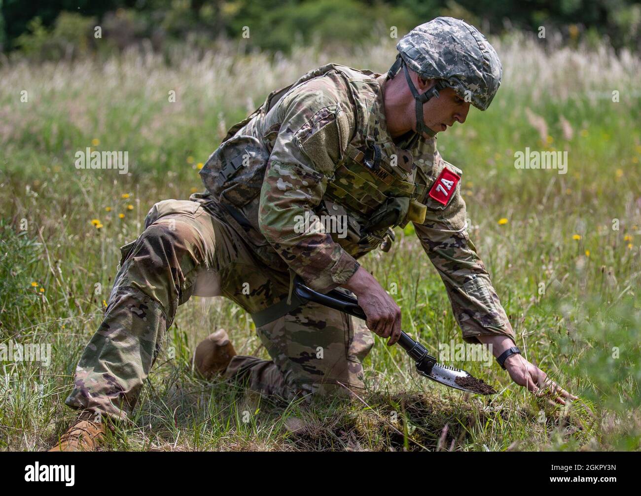 Spc. Colin Hofmann, from Medical Department Activity – Alaska, digs an individual fighting position during the Regional Health Command-Pacific’s Best Leader Competition Wednesday, June 16th 2021 at Joint Base Lewis-McChord.     The Best Leader Competition promotes esprit de corps across the Army, while  recognizing Soldiers who demonstrate the Army Values and embody the Warrior  Ethos. The competition recognizes those Soldiers who possess superb military  bearing and communication skills, in-depth knowledge of military subjects,  and the ability to perform Soldier and warrior skills at levels Stock Photo