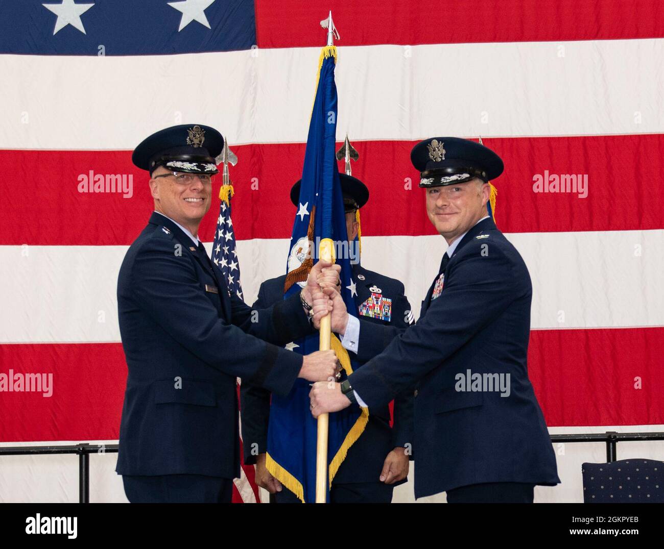 U.S. Air Force Maj. Gen. Mark Weatherington, Eighth Air Force and Joint-Global Strike Operations Center commander, passes the unit flag to Col. Daniel Diehl, in-coming 509th Bomb Wing commander, during the 509th BW change of command ceremony, Whiteman Air Force Base, Missouri, June 16, 2021. Diehl transitioned to Whiteman AFB from Dyess AFB, Texas, where he commanded the 7th Operations Group -- Air Force Global Strike Command’s largest B-1 bomb group. At Whiteman, Diehl will be responsible for the combat readiness of the Air Force’s only B-2 Spirit wing and supporting installation functions. Stock Photo