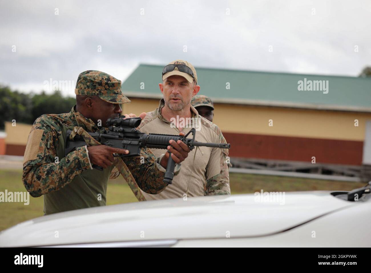 A Drug Enforcement Administration (DEA) agent guides a Jamaica Defence ...