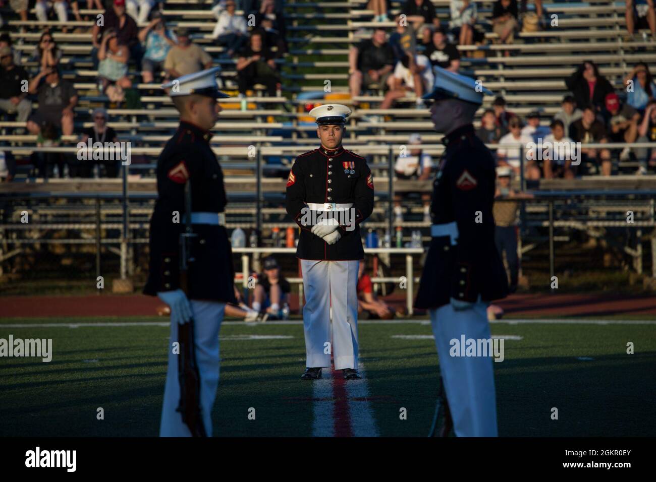 Corporal Xavier Cockrell, number one rifle inspector, Silent Drill Platoon, stands at ceremonial-at-ease during the Basilone Bowl halftime show at Bridgewater-Raritan High School, Raritan, N.J., June 16, 2021. The Basilone Bowl is an All-Star Football game which features the Devil Dogs versus the Leathernecks and is played in honor of GySgt. John Basilone, a Medal of Honor and Navy Cross recipient. Stock Photo