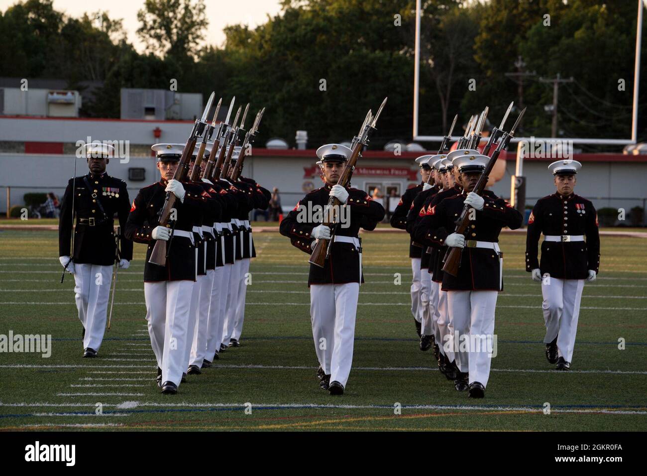 Marines with the Silent Drill Platoon march off the field during the Basilone Bowl halftime show at Bridgewater-Raritan High School, Raritan, N.J., June 16, 2021. The Basilone Bowl is an All-Star Football game which features the Devil Dogs versus the Leathernecks and is played in honor of GySgt. John Basilone, a Medal of Honor and Navy Cross recipient. Stock Photo
