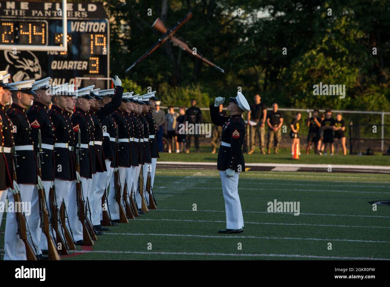 Corporal Xavier Cockrell, number one rifle inspector, Silent Drill Platoon, conducts a rifle inspection during the Basilone Bowl halftime show at Bridgewater-Raritan High School, Raritan, N.J., June 16, 2021. The Basilone Bowl is an All-Star Football game which features the Devil Dogs versus the Leathernecks and is played in honor of GySgt. John Basilone, a Medal of Honor and Navy Cross recipient. Stock Photo
