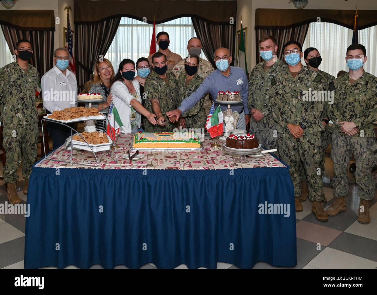 210616-N-GK686-1020 NAVAL AIR STATION SIGONELLA, Italy (June 16, 2021)  Cmdr. Ronald Cappellini, executive officer, Naval Air Station (NAS)  Sigonella and NAS Sigonella Command Master Chief Anna Wood, center, along  with Ristorante Bella