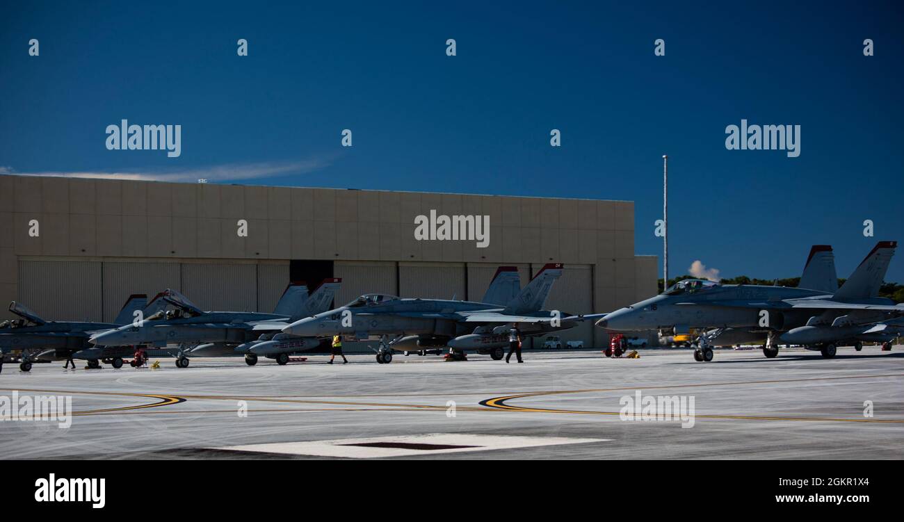 U.S. Marine Corps F/A-18C assigned to Marine Fighter Attack Squadron 232, park on an apron at Andersen Air Force Base, Guam, June 16, 2021. VMFA 232 crew flew to Andersen as part of the Aviation Training Relocation program, which is designed to increase operational readiness, improve interoperability and meet training requirements Stock Photo