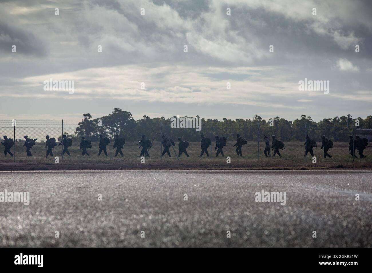 U.S. Marines with Charlie Company, 1st Battalion, 7th Marine Regiment with Marine Rotational Force - Darwin, walk to the tarmac at Gove Airport towards an MV-22B Osprey in Nhulunbuy, NT, Australia, June 17, 2021. Marines redeployed from Nhulunbuy to Darwin on MV-22B Ospreys after the successful completion of Exercise Darrandarra. Darrandarra, meaning “together,” demonstrates the Marines Corps’ ability to operate with the Australian Defence Force and reinforce embassies and conduct noncombatant evacuation operations in response to crises and contingencies in the Indo-Pacific region. Stock Photo