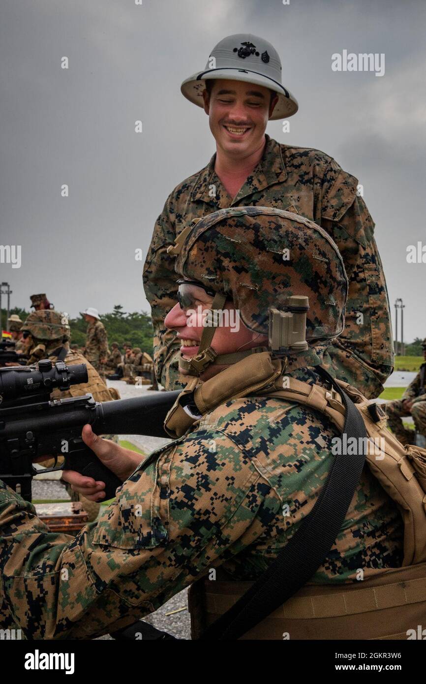 . Marine Corps Lance Cpl. Jacob A. Moses, a combat marksmanship coach  (CMC) with Headquarters and Support Battalion, Marine Corps Installations  Pacific, coaches a shooter, June 17, 2021, on Camp Hansen, Okinawa,