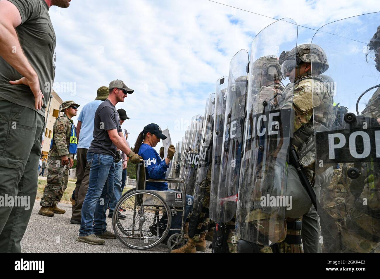 U.S. Air Force security forces members wearing civilian clothing act as protestors in a crowd control exercise that leads to simulated arrests made by the civilian law enforcement agencies during PATRIOT 21 June 17, 2021 at Fort McCoy, Wisconsin. PATRIOT 21 is a training exercise designed for military members to work alongside civilian emergency management and first responders in the same manner they would during a natural disaster so that in the case of a real-world disaster all agencies can maximize their response efforts, provide necessary resources to the communities affected and save more Stock Photo