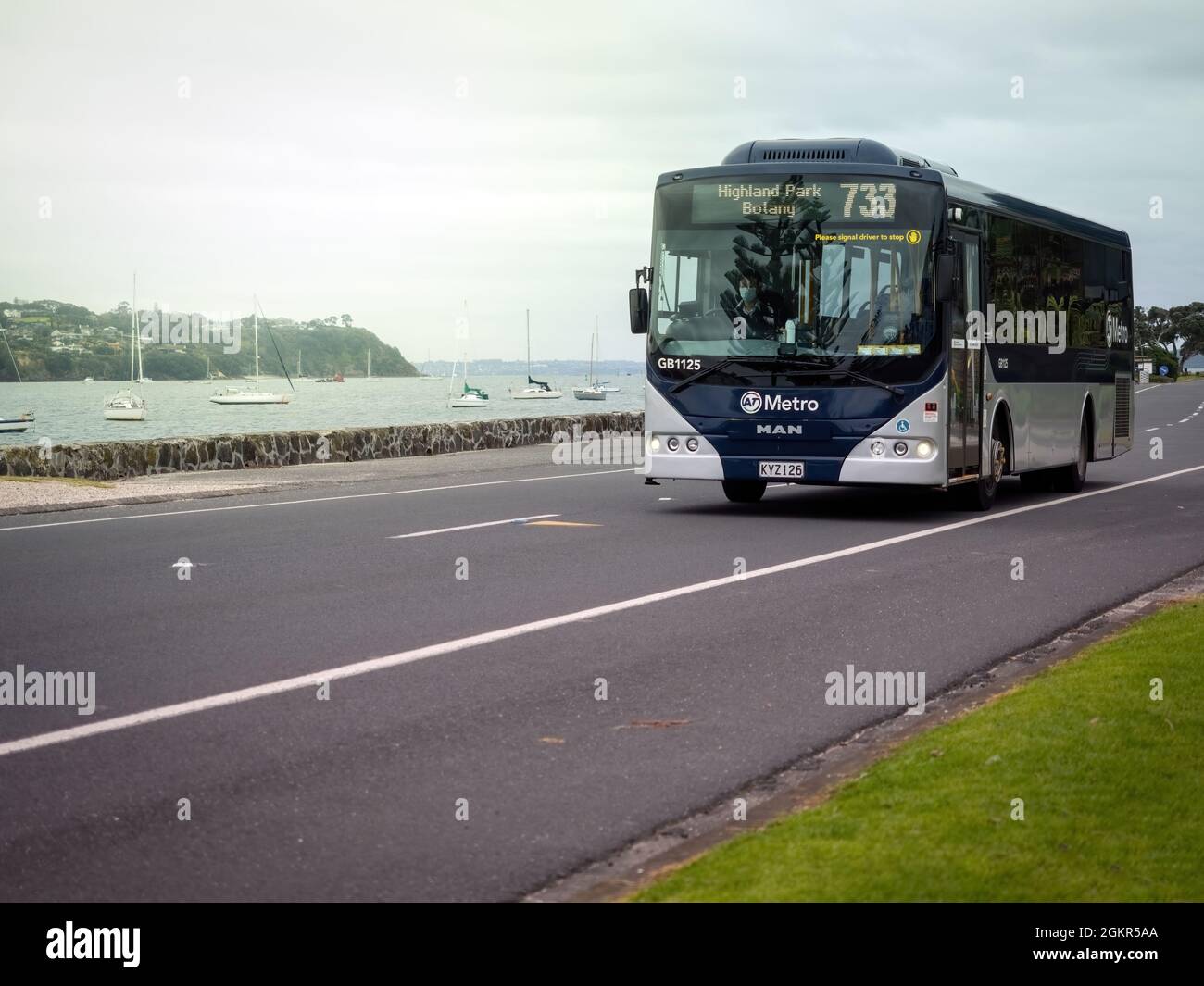 AUCKLAND, NEW ZEALAND - Jul 07, 2021: An AT Metro bus at the Parade in Bucklands Beach in Auckland, New Zealand on a gloomy day Stock Photo