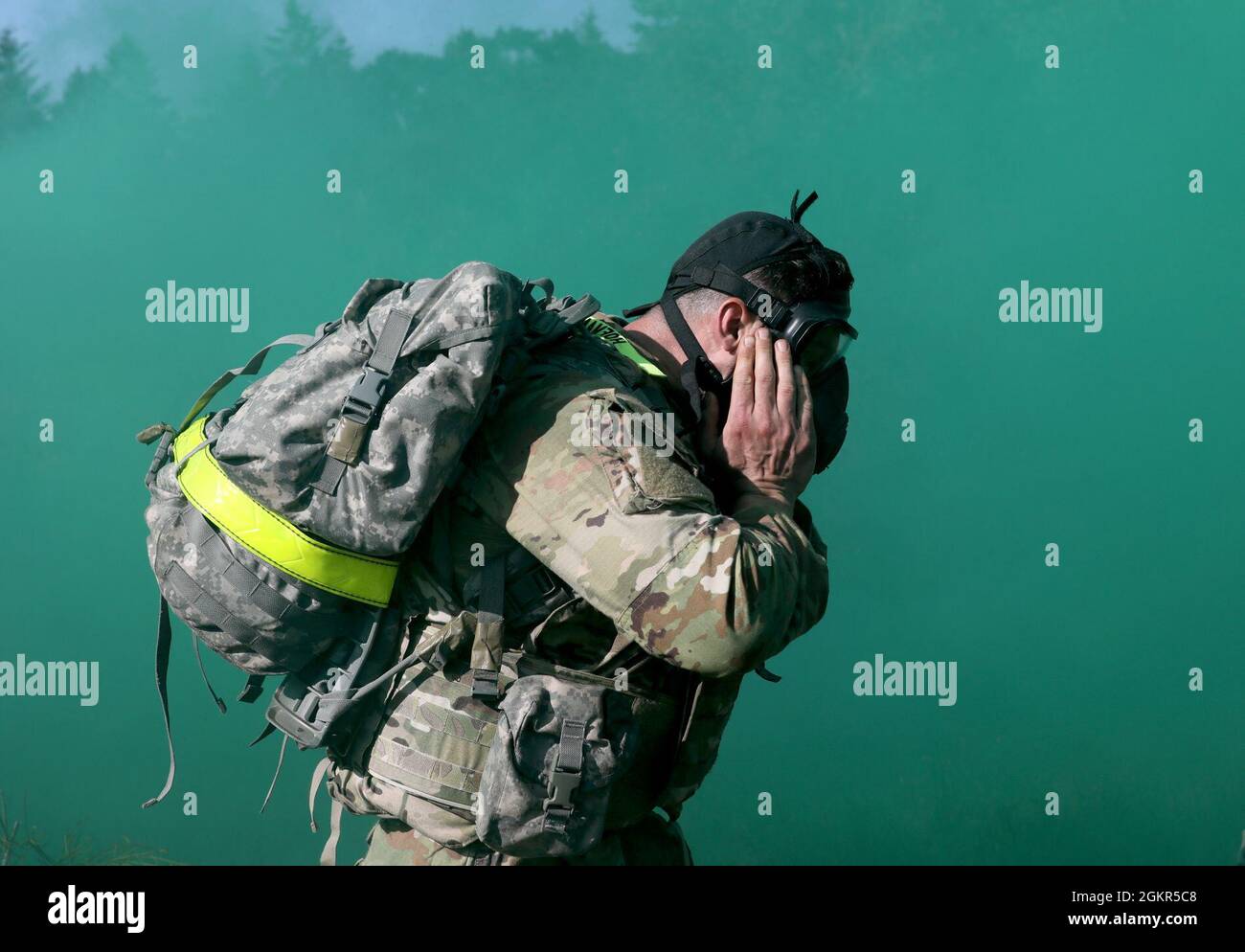 Spc. Colin Hoffmann, assigned to U.S. Army Medical Department Activity-Alaska, clears his protective mask during a simulated gas attack, Regional Health Command-Pacific Best Leader Competition, Joint Base Lewis-McChord, Wash., June 17, 2021. Both are assigned to U.S> Army Medical Department Activity-Alaska. The Best Leader Competition promotes esprit de corps across the Army, while recognizing Soldiers who demonstrate the Army Values and embody the Warrior Ethos. The competition recognizes those Soldiers who possess superb military bearing and communication skills, in-depth knowledge of milita Stock Photo