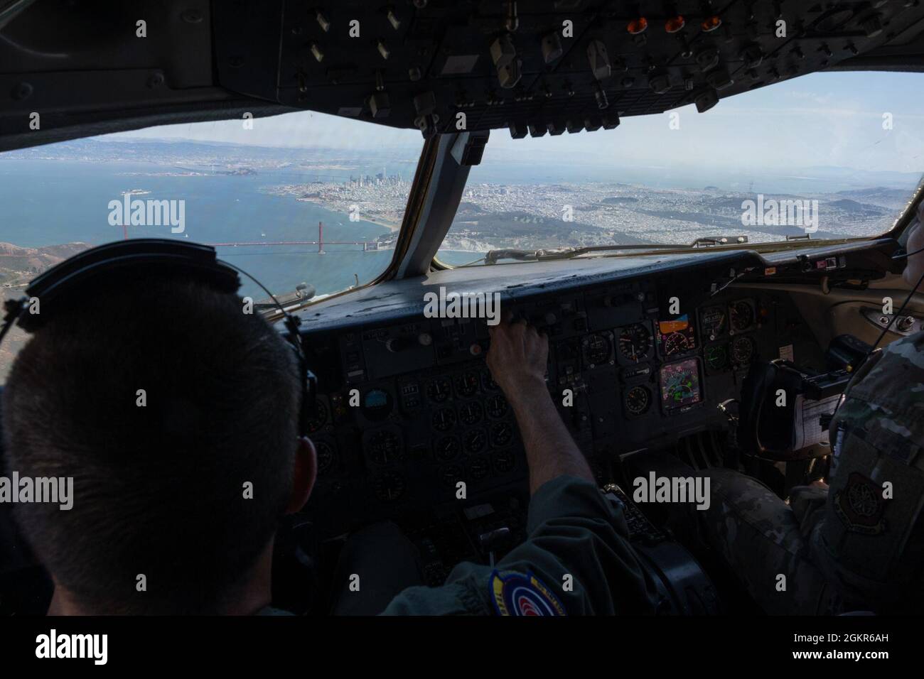 U.S. Air Force Col. Zachery Jiron, 60th Air Mobility Wing vice commander, left, and Capt. Karen Miller, 6th Air Refueling Squadron KC-10 Extender pilot, fly over San Francisco during Jiron’s fini flight June 17, 2021. Final flight, also known as fini flight, is a tradition for pilots and some aircrew members who are retiring or moving to another base. Part of the tradition is getting hosed with water as soon as they step out of the aircraft after the flight. Stock Photo