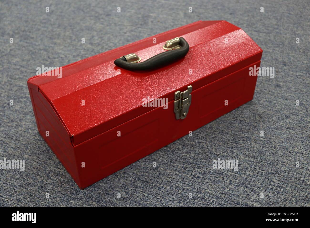 A red tool box that contains a lot of tools, this box makes it easier for workers to store their tools and carry them when needed, and can reduce work Stock Photo