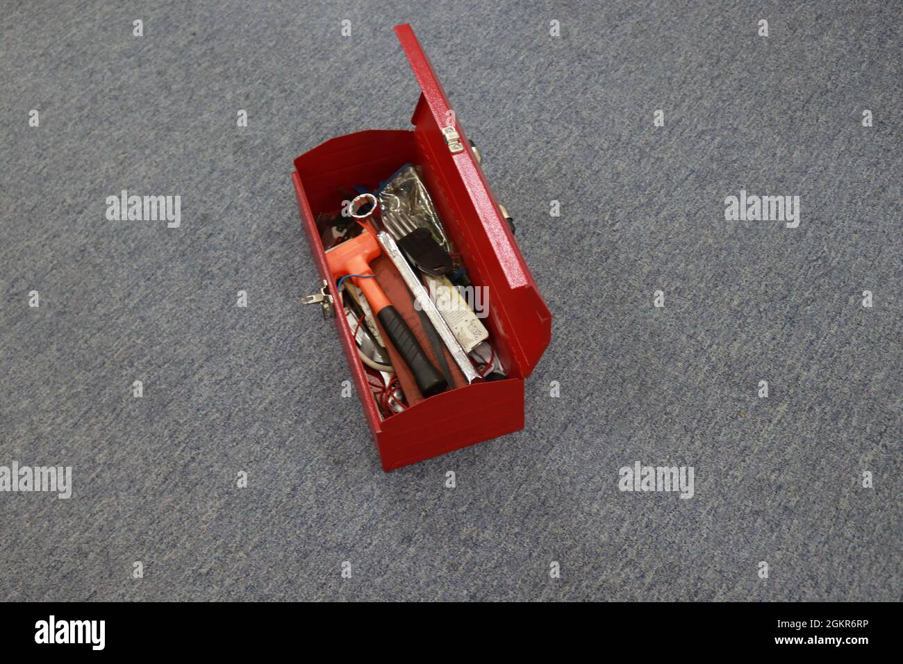 A red tool box that contains a lot of tools, this box makes it easier for workers to store their tools and carry them when needed, and can reduce work Stock Photo