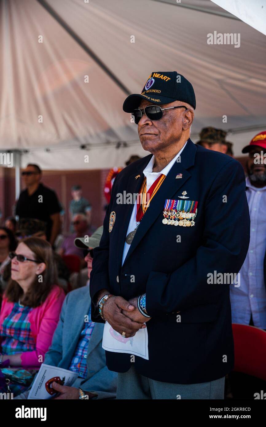 Former U.S. Marine Corps Maj. James Capers, the distinguished guest, stands for the 2d Marine Division (MARDIV) song “Follow Me” during a change of command ceremony for 2d Reconnaissance Battalion (Recon), 2d MARDIV, on Camp Lejeune, N.C., June 18, 2021. During the ceremony, Lt. Col. Geoffrey Hoey relinquished command of 2d Recon to Lt. Col. Eric Tee. Stock Photo