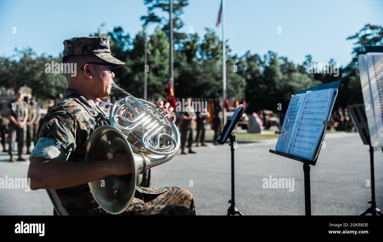 U.S. Marine Corps Sgt. Andrew Jan, a french horn player with the 2d Marine Division (MARDIV) Band, plays introductory music during a change of command ceremony for 2d Reconnaissance Battalion (Recon), 2d MARDIV, on Camp Lejeune, N.C., June 18, 2021. During the ceremony, Lt. Col. Geoffrey Hoey relinquished command of 2d Recon to Lt. Col. Eric Tee. Stock Photo