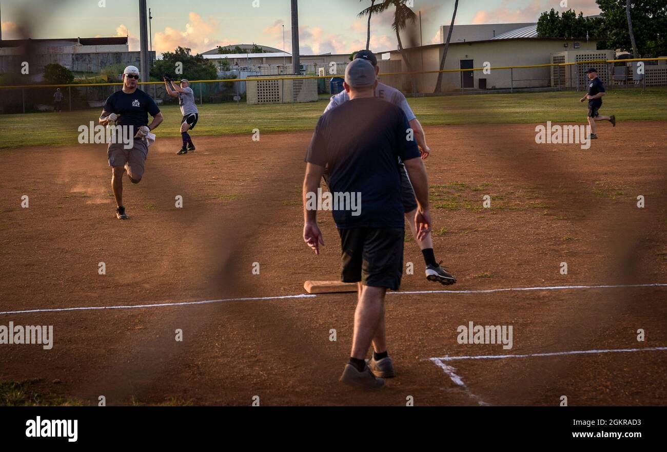 U.S. Air Force Chief Master Sgt. Michael Cox, superintendent assigned to the 36th Operations Support Squadron, runs to third base during the Chief’s versus Eagle’s softball game at Andersen Air Force Base, Guam, June 18, 2021. The final score ended with the Eagle’s defeating the Chief’s 18 to 14. Stock Photo