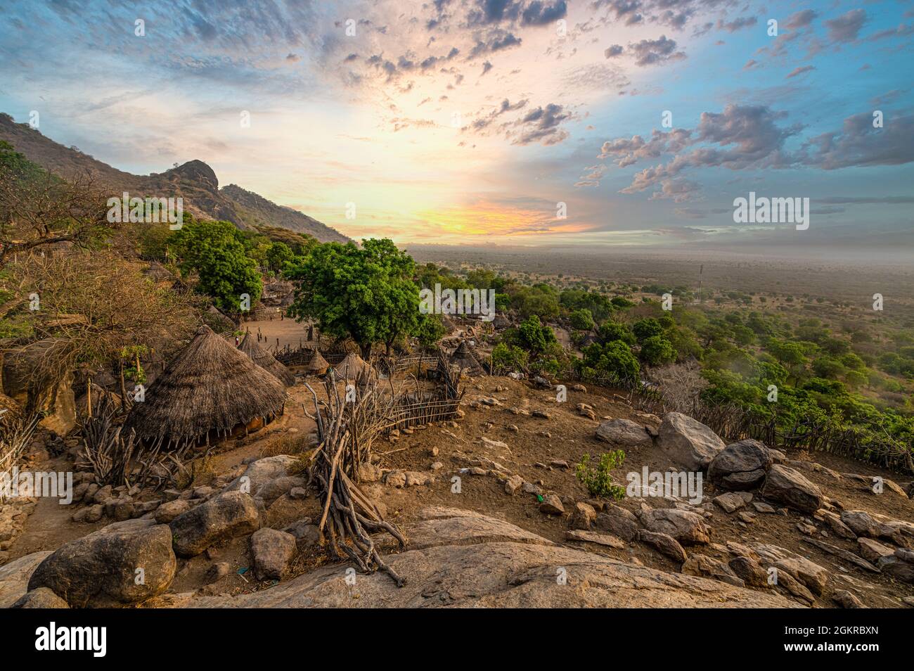Sunset over traditional huts of the Otuho (Lotuko) tribe, Imatong mountains, Eastern Equatoria, South Sudan, Africa Stock Photo