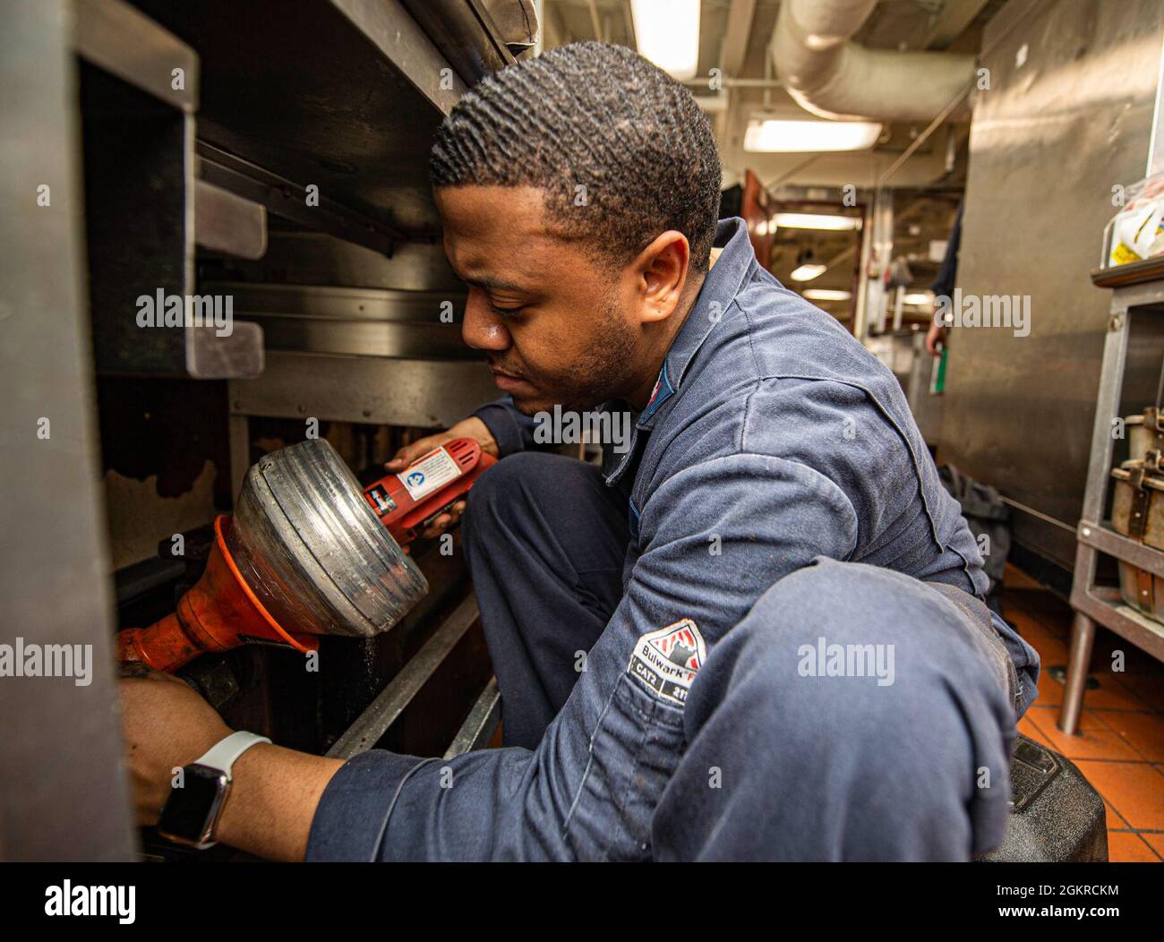 210619-N-IG124-1020 ATLANTIC OCEAN (June 19, 2021) Hull Maintenance Technician 3rd Class Trinity Carter, from Enfield, North Carolina, uses a hand snake to remove a clog from a grease trap in a scullery aboard the Nimitz-class aircraft carrier USS Harry S. Truman (CVN 75) during Tailored Ship’s Training Availability (TSTA) and Final Evaluation Problem (FEP). Harry S. Truman, with embarked Carrier Air Wing 1, is underway conducting TSTA and FEP to assess their ability to conduct combat missions, support functions and survive complex casualty control situations in preparation for full integratio Stock Photo