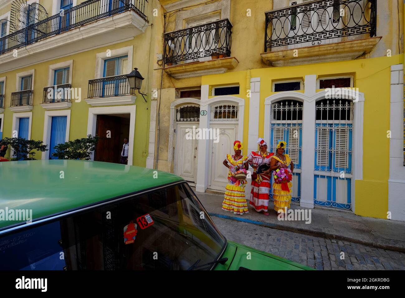 Three colorful ladies in traditional dress, Old Havana, Cuba, West Indies, Central America Stock Photo