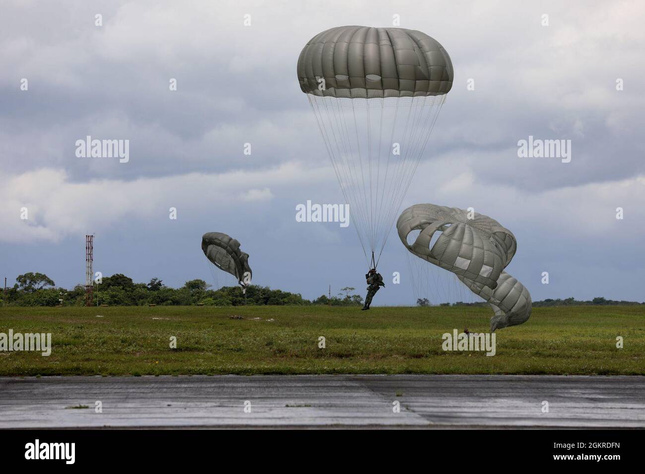 Brazilian Marine Corps (BMC) Cmdr. Gustavo Soares Gomes with BMC  Headquarters is assisted by a U.S. Soldier with 3rd Battalion, 7th Special  Forces Group before parachute training during Tradewinds 2021, Air Station