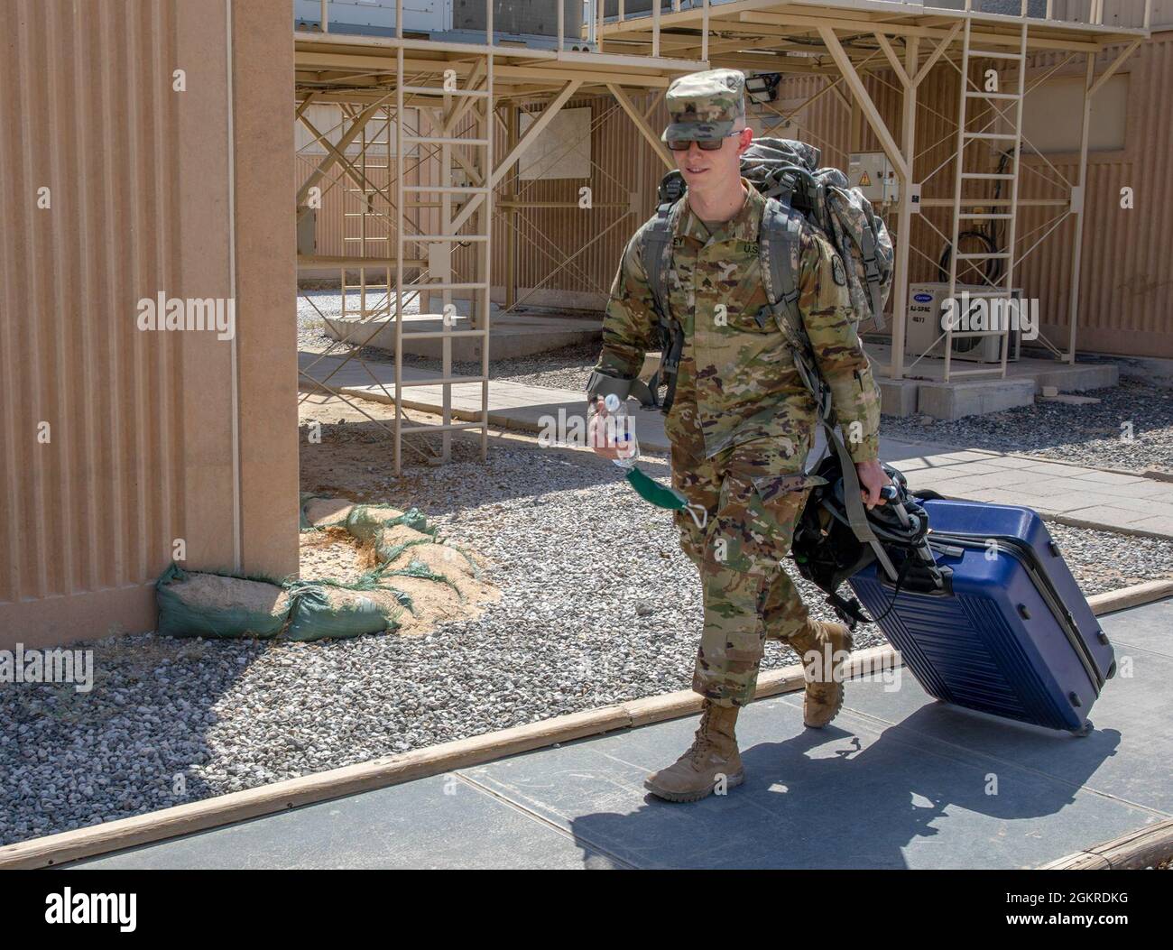 Sgt. Brandon Brantley, a Chemical, Biological, Radiological, and Nuclear Specialist with 25th Strategic Signal Battalion, makes his way to the barracks during in-processing for the U.S. Army Central 2021 Best Warrior Competition at Camp Arifjan, Kuwait, June 20, 2021. Eleven Soldiers will compete in various events that will test their physical and mental readiness as well as their technical and tactical knowledge. Stock Photo