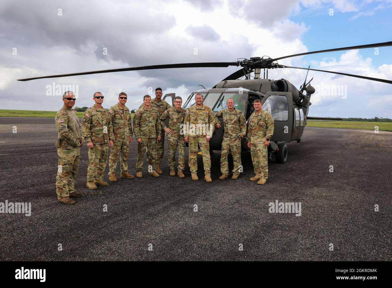 Brazilian Marine Corps (BMC) Cmdr. Gustavo Soares Gomes with BMC  Headquarters is assisted by a U.S. Soldier with 3rd Battalion, 7th Special  Forces Group before parachute training during Tradewinds 2021, Air Station