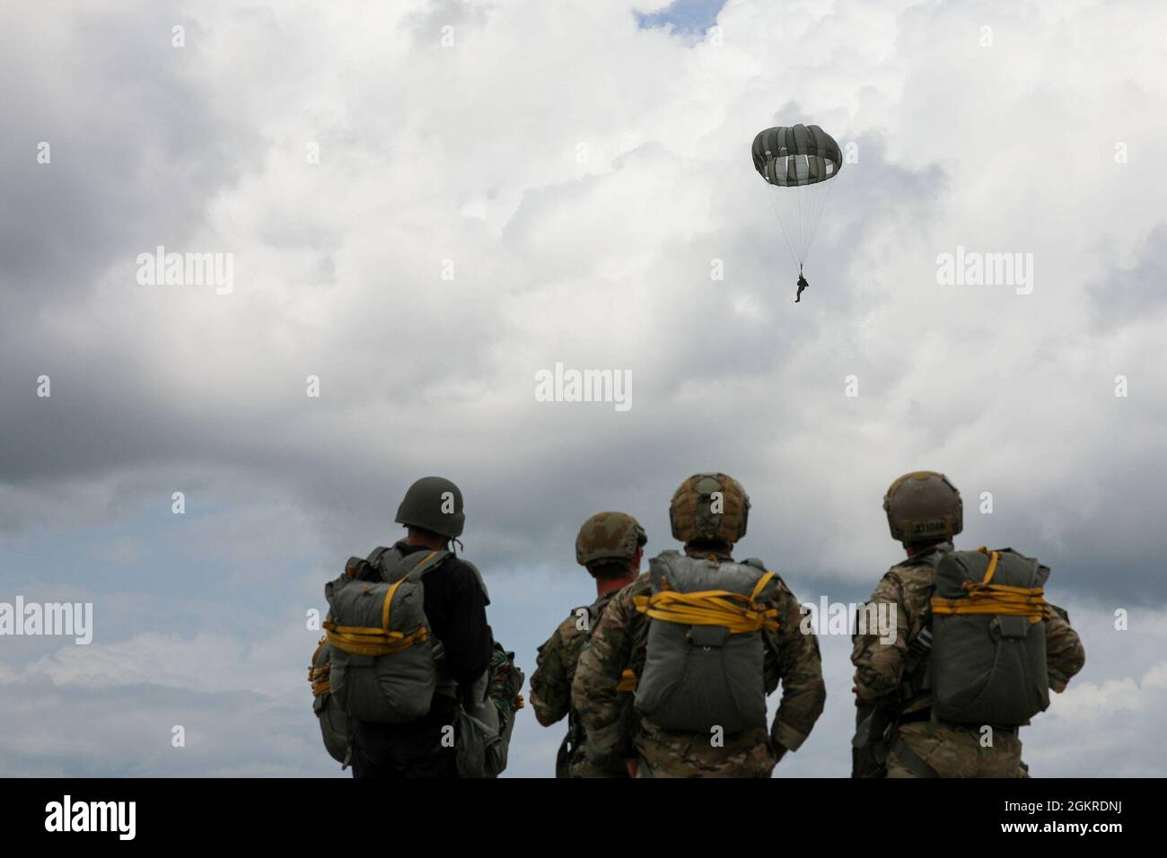 Brazilian Marine Corps (BMC) Cmdr. Gustavo Soares Gomes with BMC  Headquarters is assisted by a U.S. Soldier with 3rd Battalion, 7th Special  Forces Group before parachute training during Tradewinds 2021, Air Station