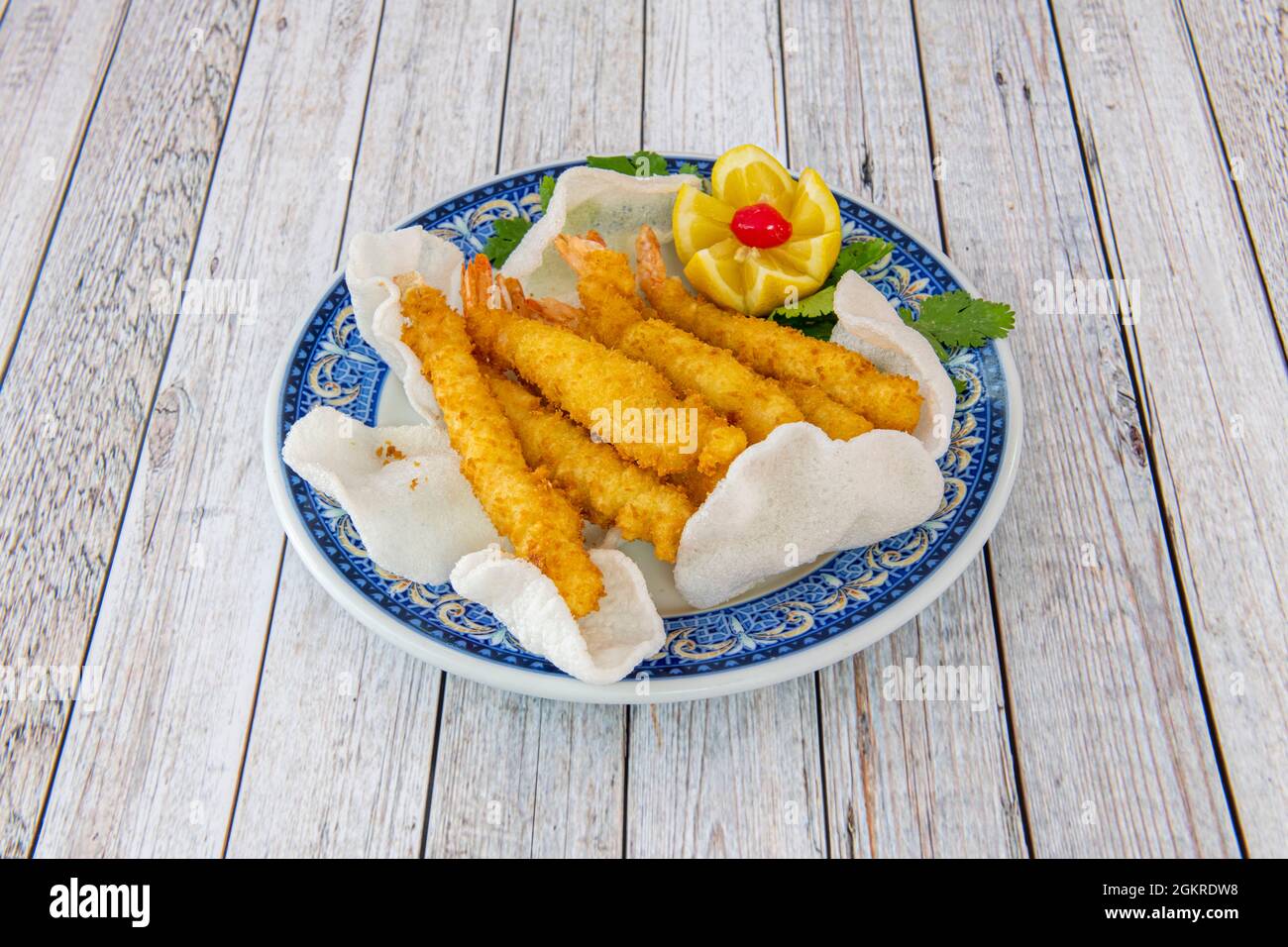 Fried tempura prawns in a Chinese restaurant with prawn bread on a blue
