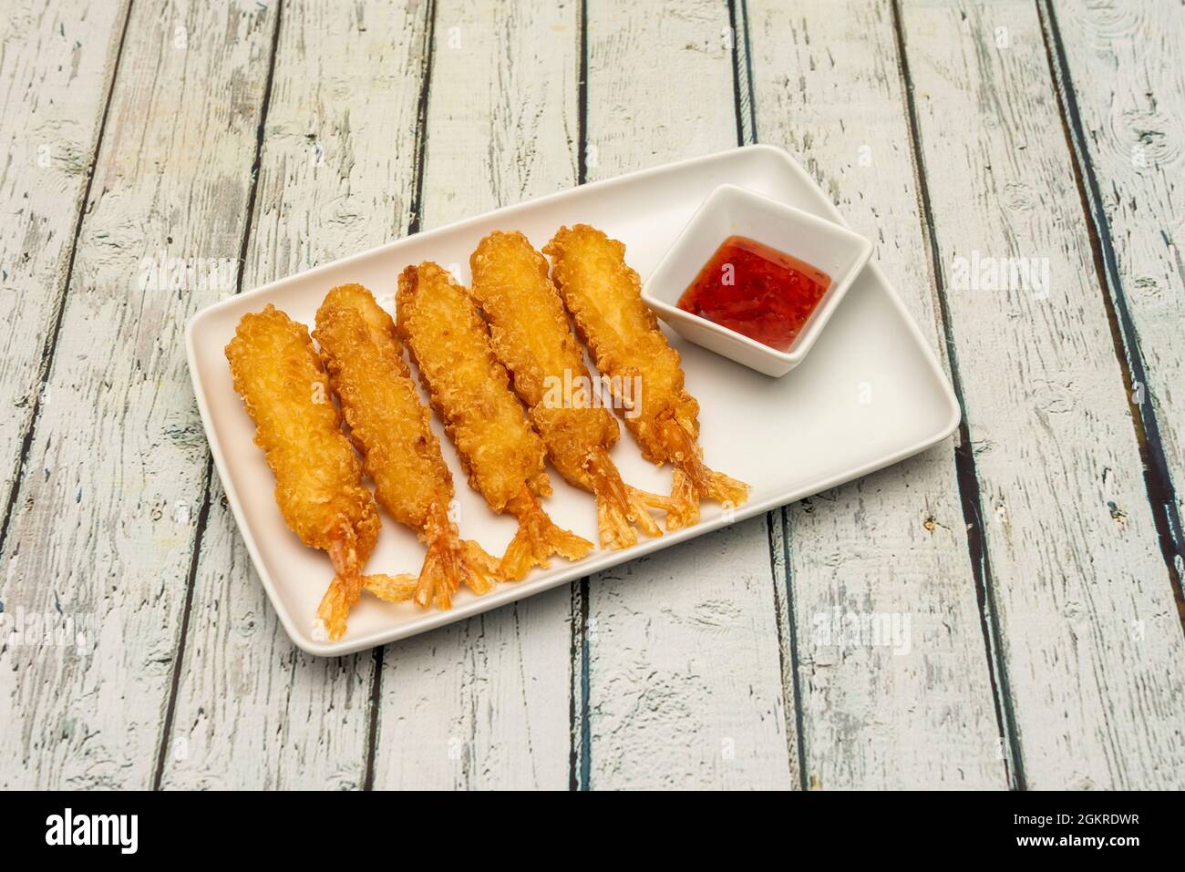Delicious looking tempura prawns with sweet and sour dipping sauce cooked by a Chinese chef