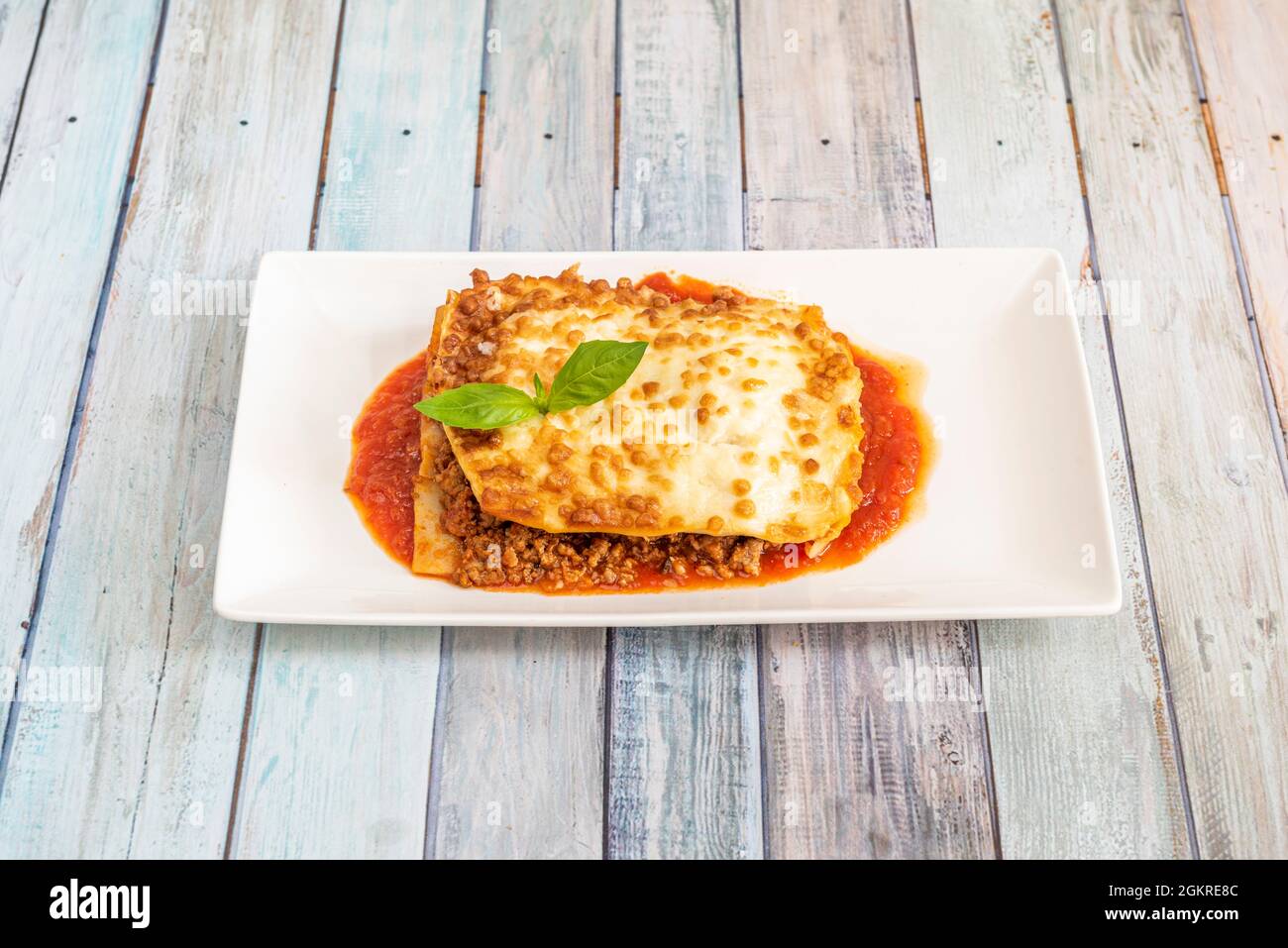 Delicious portion of minced meat lasagna with tomato sauce and bechamel covering the pasta
