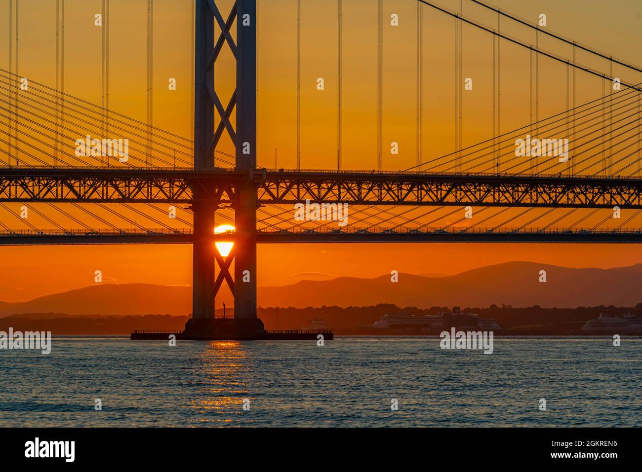 View of the Forth Road Bridge and Queensferry Crossing over the Firth of Forth at sunset, South Queensferry, Edinburgh, Lothian, Scotland Stock Photo