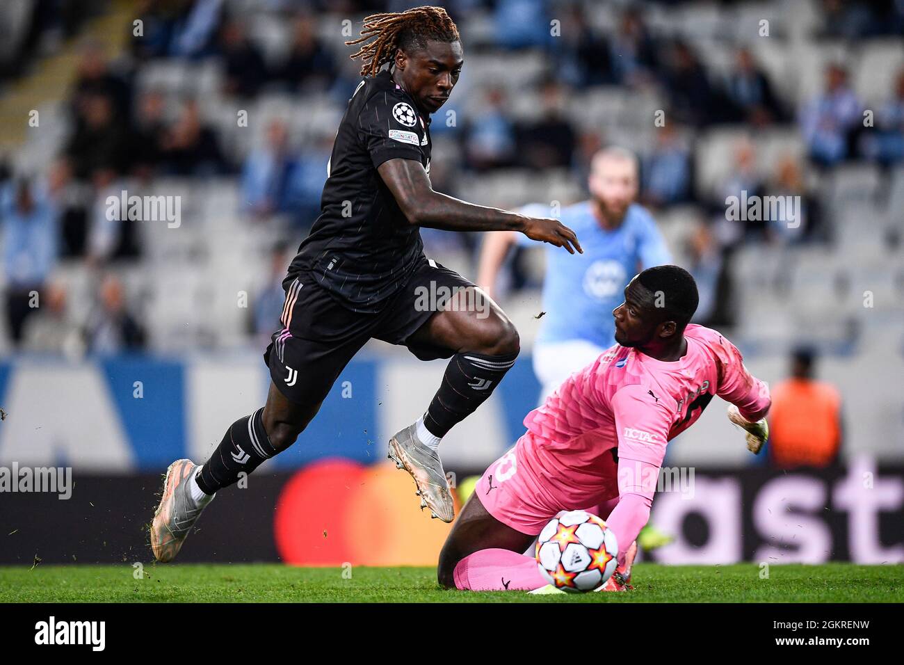 Malmo, Sweden. 14 September 2021. Moise Kean (L) of Juventus FC and Ismael Diawara of Malmo FF compete for the ball during the UEFA Champions League football match between Malmo FF and Juventus FC. Credit: Nicolò Campo/Alamy Live News Stock Photo