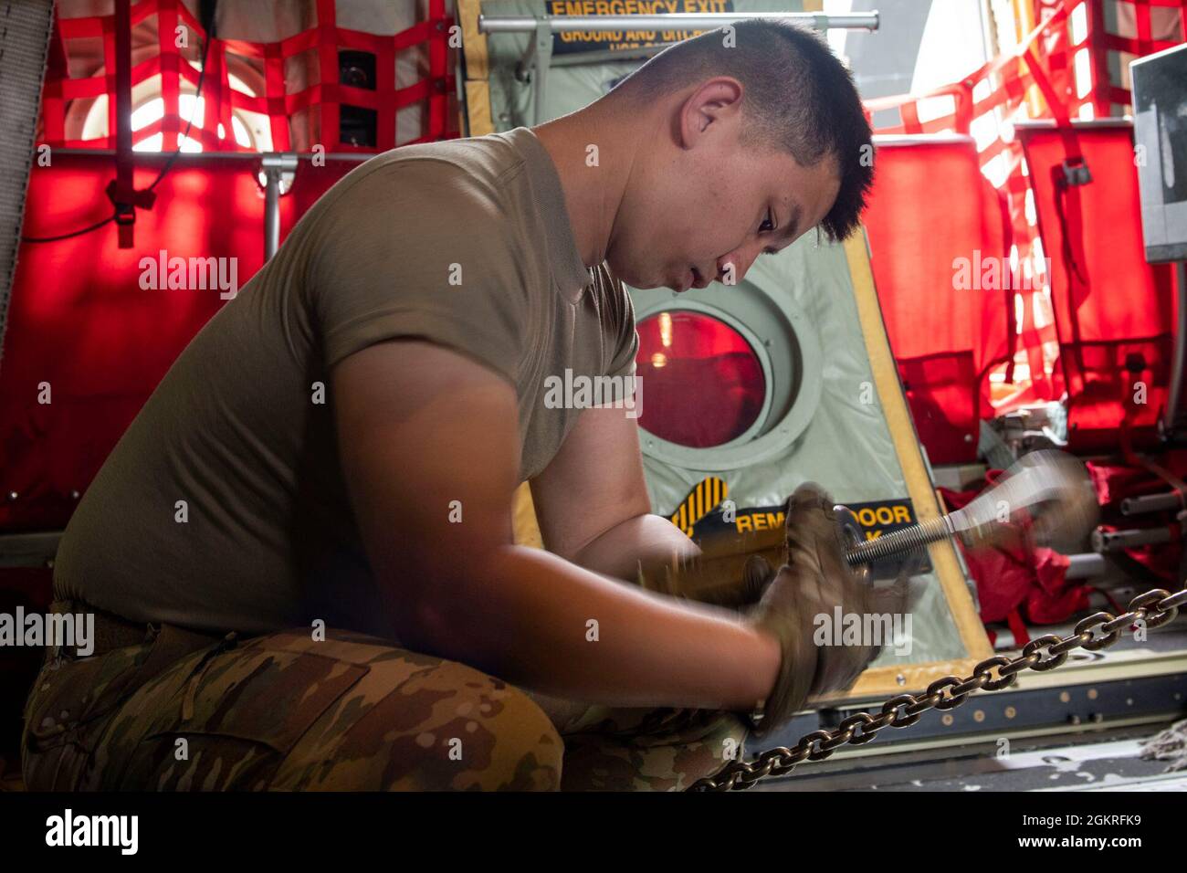 U.S. Air Force Staff Sgt. Jaypeter Tuazon, a loadmaster assigned to the 36th Airlift Squadron, Yokota Air Base, Japan, secures a R-11 Refueler in a C-130J Super Hercules during exercise RED FLAG-Alaska 21-2 at Joint Base Elmendorf-Richardson, Alaska, June 21, 2021. The 36th AS shipped the Refueler to Eielson Air Force Base, Alaska in support of the exercise’s flying operations. RF-A 21-2 is a Pacific Air Forces-sponsored exercise designed to provide realistic training in a simulated combat environment.  A series of commander-directed field training exercises provides joint offensive counter-ai Stock Photo