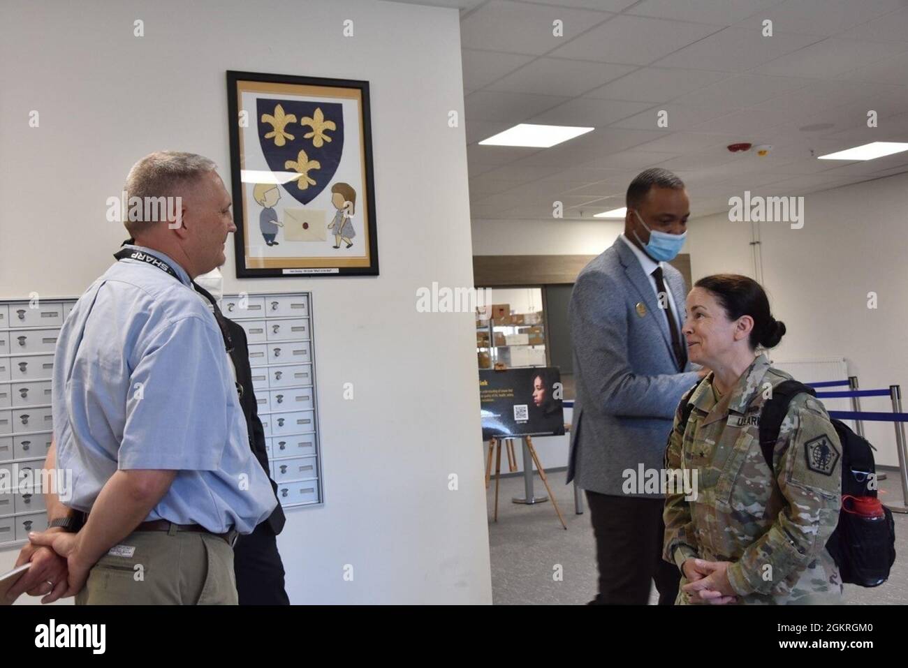 WIESBADEN, Germany—Brig. Gen. Hope C. Rampy, the Army's Adjutant General,  speaks with Chris Pittman, Directorate of Human Resources, during her tour  of the post office while James McKee, supervisory postal program specialist,