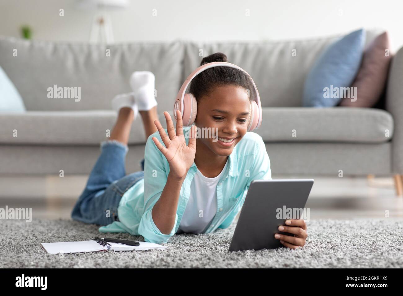 Happy african american lady studying at home on tablet, calling online ...