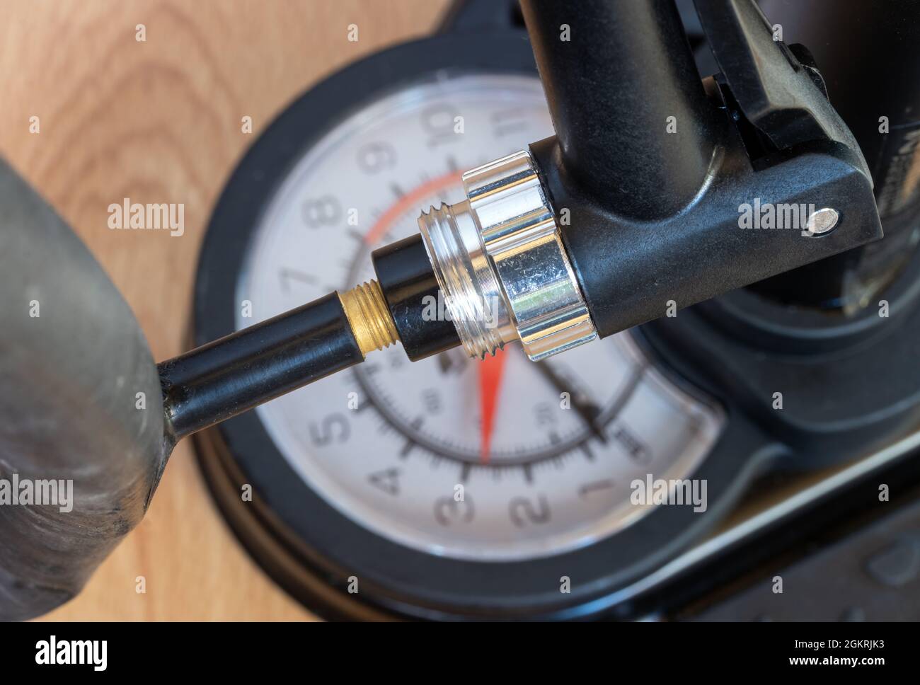 Closeup view of a pump with manometer blowing air into a valve of