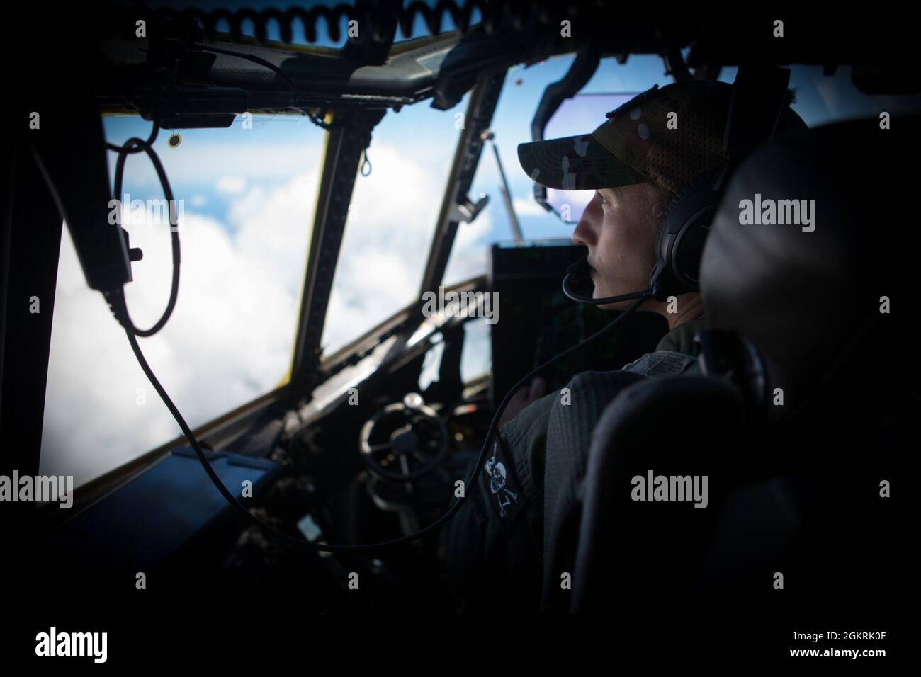 210621-M-WI555-0109 PACIFIC OCEAN (June 21, 2021) Maj. Catherine Burns, a KC-130J Hercules pilot with Marine Aerial Refueler Transport Squadron (VMGR) 352, Marine Aircraft Group (MAG) 11, 3rd Marine Aircraft Wing (MAW), I Marine Expeditionary Force (MEF), observes the Pacific Ocean, June 21. VMGR-352 is currently conducting routine operations in U.S. 3rd Fleet. Stock Photo