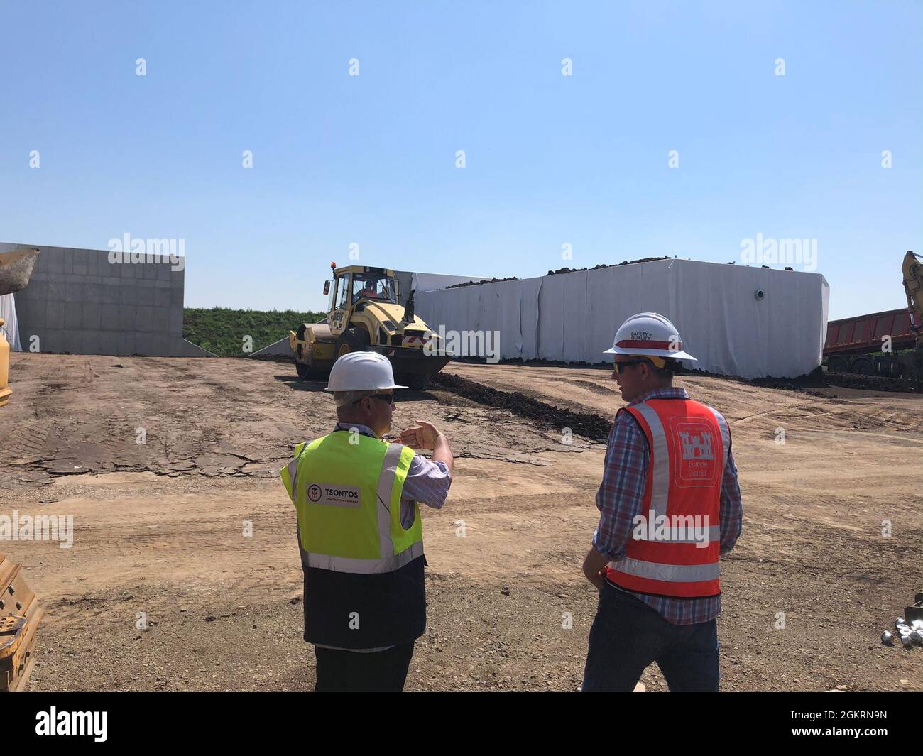 U.S. Army Corps of Engineers, Europe District Project Engineer Kevin Gray, right, discusses progress on various construction projects at Campia Turzii Air Base, Romania with a contractor June 22, 2021. The U.S. Army Corps of Engineers is managing a growing construction mission at Campia Turzii that is part of the European Deterrence Initiative, being implemented by the U.S. European Command. The EDI enables the United States to enhance the U.S. deterrence posture, increase the readiness and responsiveness of U.S. forces in Europe, support the collective defense and security of NATO allies, and Stock Photo