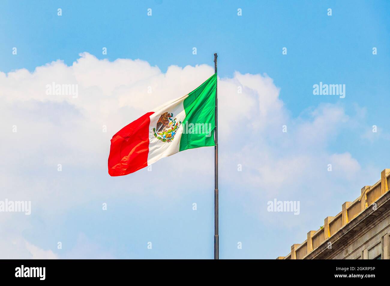 Mexican flag green white red with blue sky in the center of Mexico City ...