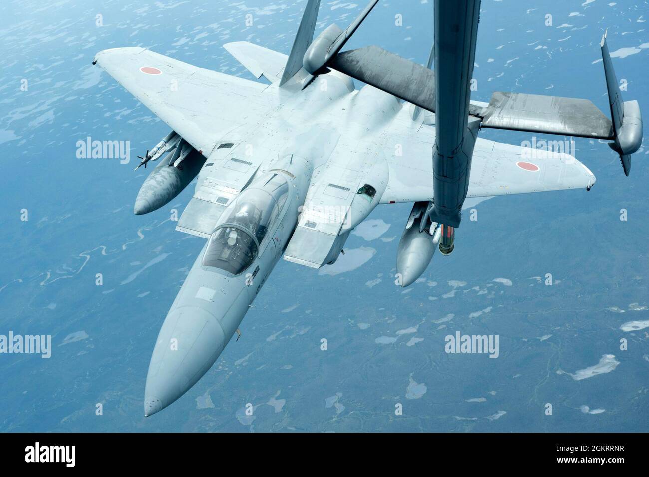 A Japanese Air Self Defense Force F-15J Eagle proceeds to refuel from a U.S. Air Force KC-10 Extender assigned to the 9th Air Refueling Squadron, Travis Air Force Base, California, over the Joint Pacific Alaska Range Complex June 23, 2021. RED FLAG-Alaska 21-2 is a Pacific Air Forces-sponsored exercise designed to provide realistic training in a simulated combat environment. A series of commander-directed field training exercises provides joint offensive counter-air, interdiction, close air support, and large force employment training. The RF-A exercise provides unique opportunities to integra Stock Photo